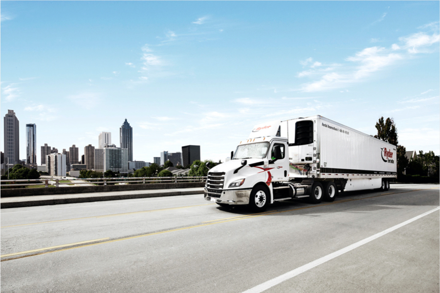 Ryder truck on highway in front of large city